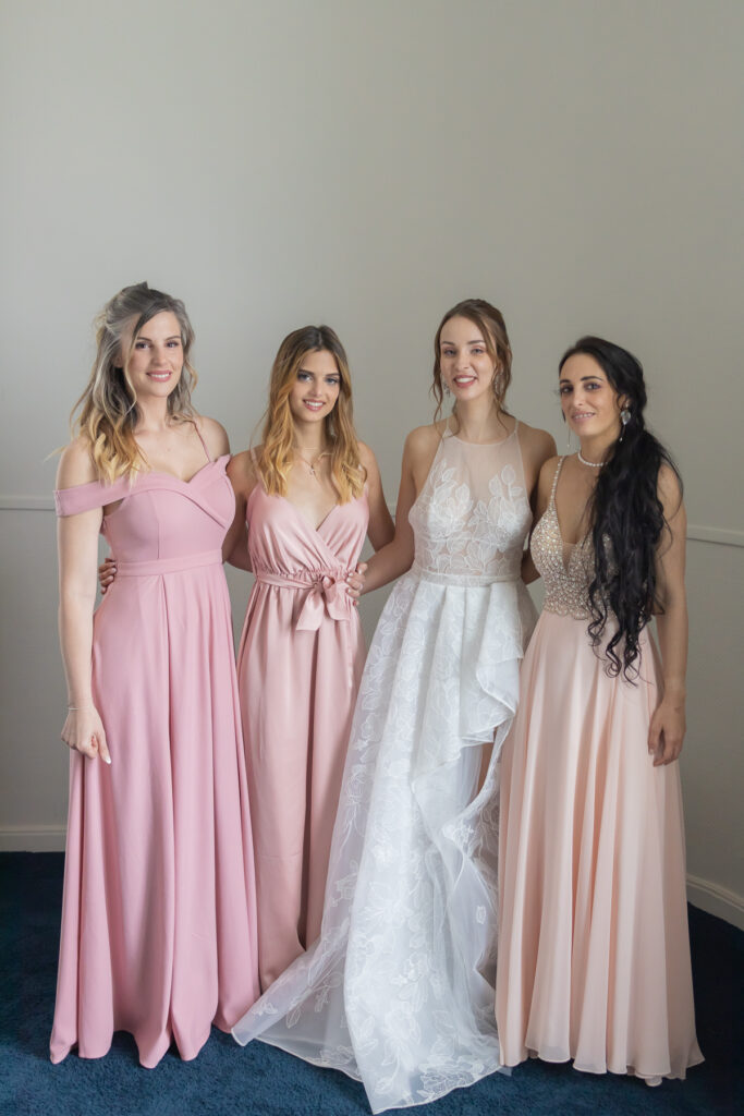 Cortège mariage les demoiselles d'honneur en robe rose poudrées posent à côté de a mariée